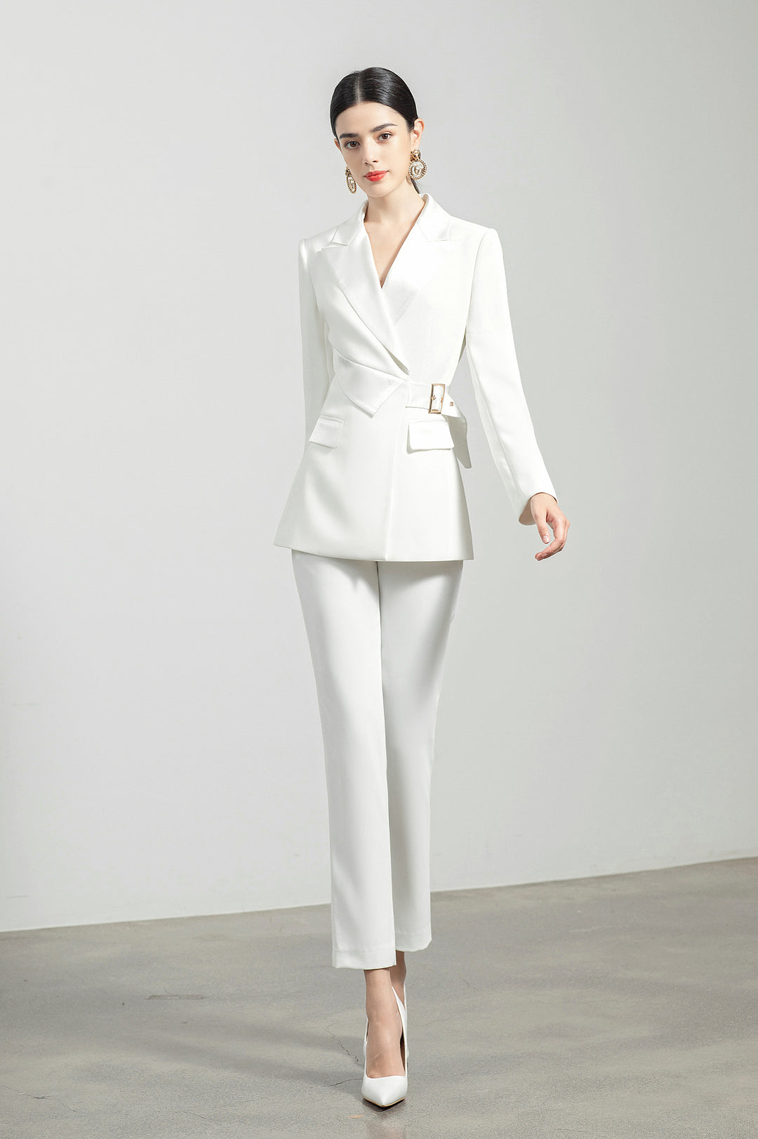 Model wearing Meliora's white Alabaster trouser suit