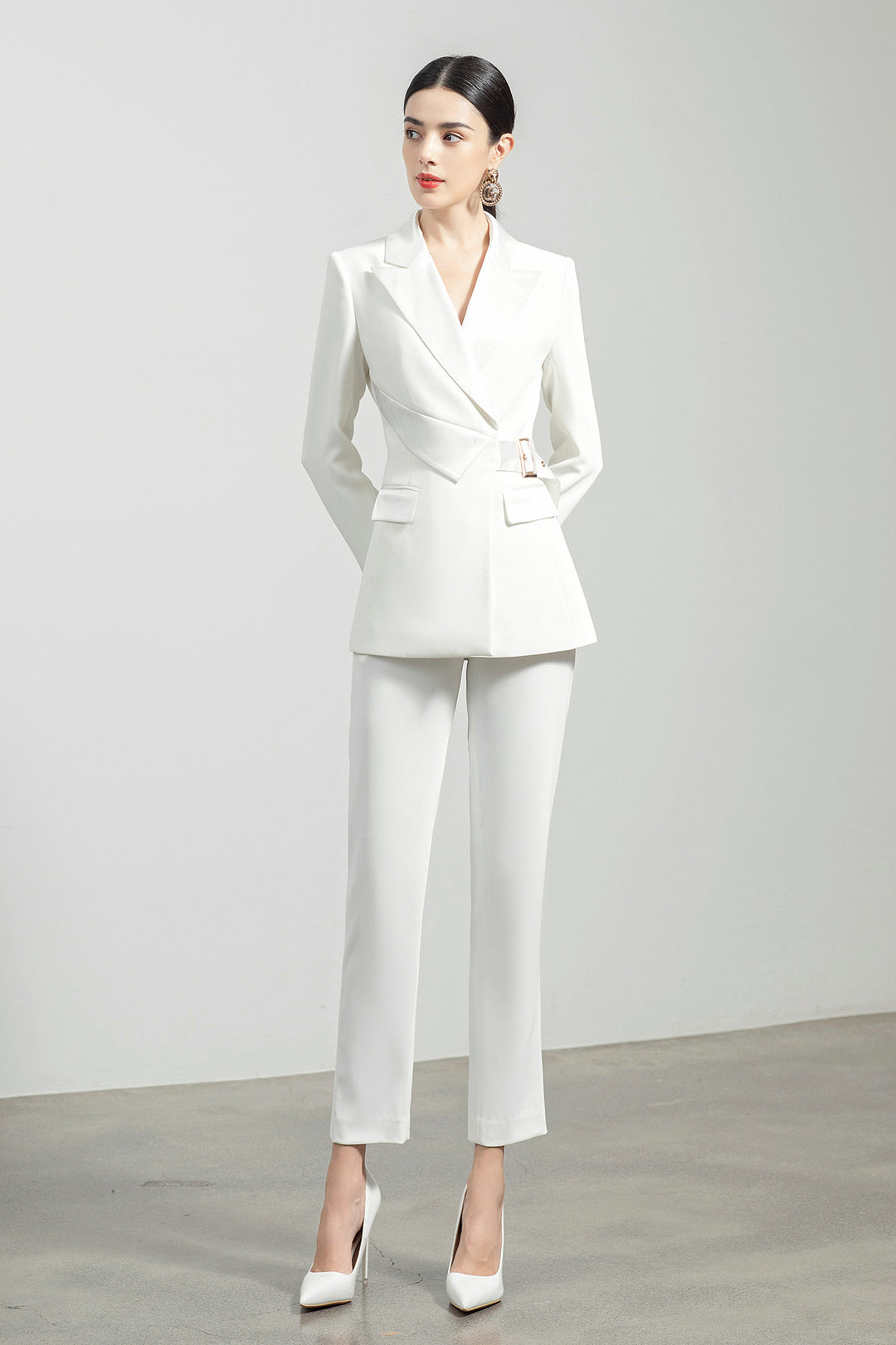 Model wearing Meliora's white Alabaster trouser suit