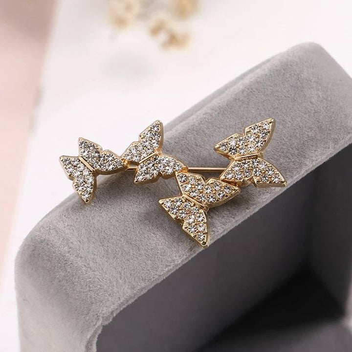 Golden butterfly brooch with elaborate rhinestone detailing worn best with the Meliora White L'eau Privee Dress. Christmas gift for her